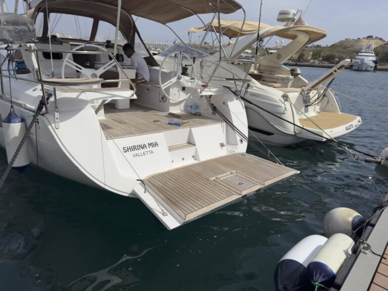 Stern and teak swim platform of Shirina Mia sailing yacht moored in the marina