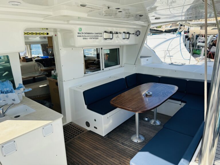 Outdoor cockpit dining area on Pupa Mia catamaran