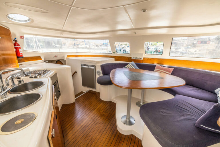 Interior galley and dinette seating aboard Chiquita catamaran