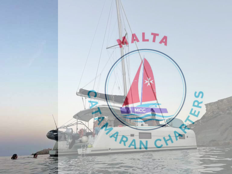 Bowie Lagoon 42 catamaran anchored near Malta's coastline at sunset with guests swimming