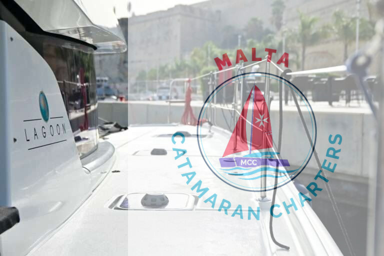 Lagoon logo on Bowie's hull, moored near Valletta's fortifications