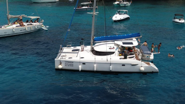 Chiquita catamaran anchored with guests swimming alongside