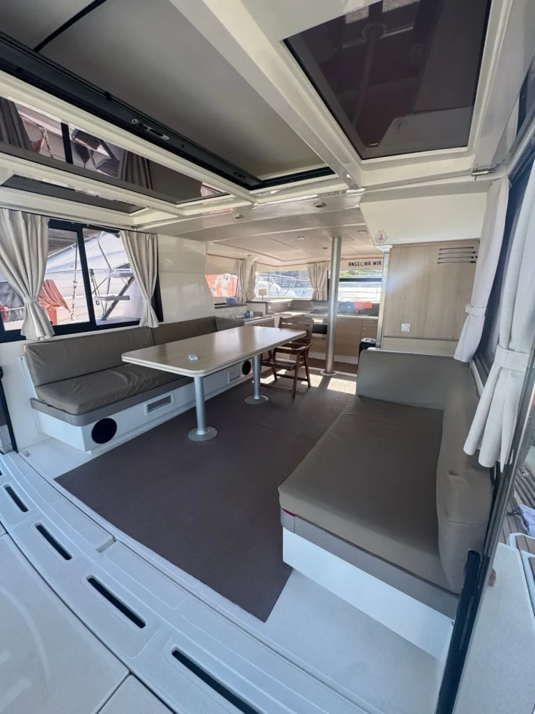 Angelina Mia catamaran cockpit seating opening onto the galley, moored in Malta