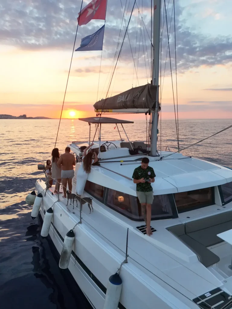 Guests enjoying a sunset charter on the deck of the Angelina Mia catamaran