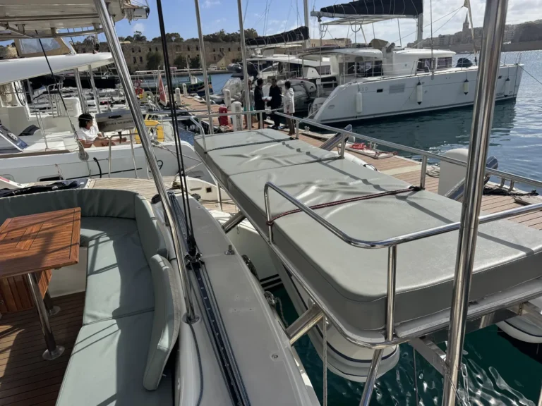 Padded sun lounger on the back deck of Cicciolina Mia catamaran