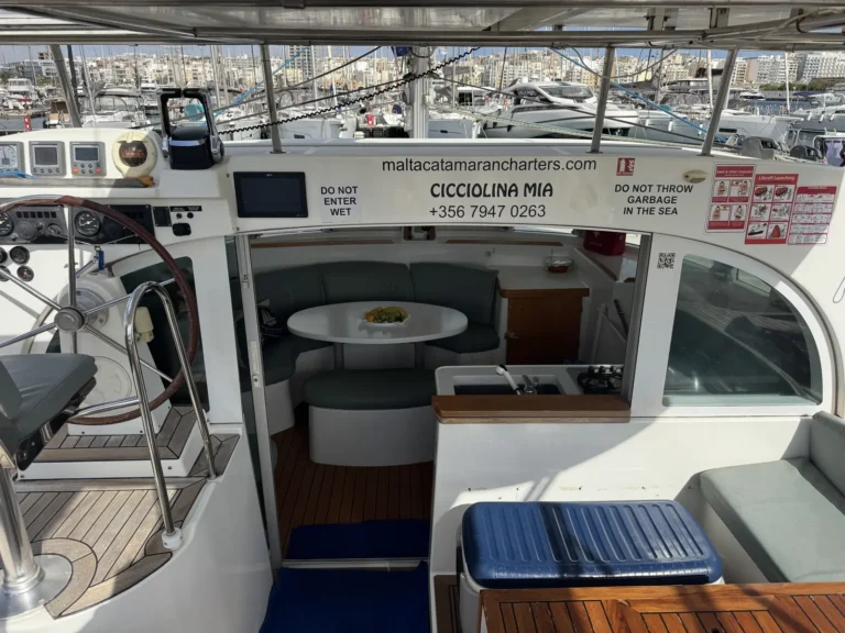 Cicciolina Mia catamaran cockpit with helm station and a view into the saloon