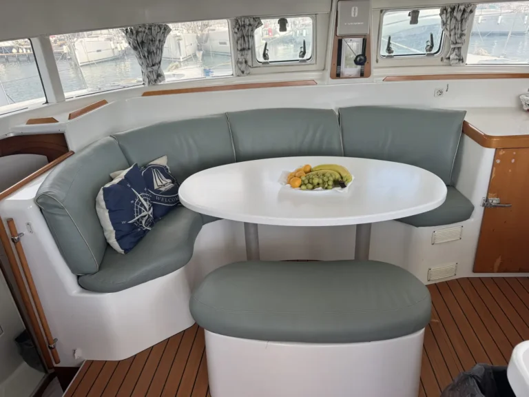 Shaded saloon on Cicciolina Mia with seating around a dining table