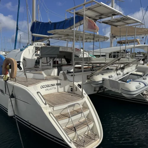 Cicciolina Mia, a Lagoon 380 catamaran, moored at the marina with its swim platform and steps