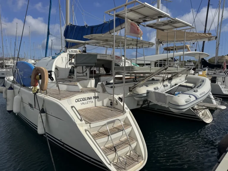 Cicciolina Mia, a Lagoon 380 catamaran, moored at the marina with its swim platform and steps